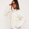 Women wearing a lemon yellow and grey striped oversized sweatshirt, front view
