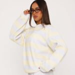 Women wearing a lemon yellow and grey striped oversized sweatshirt, front view