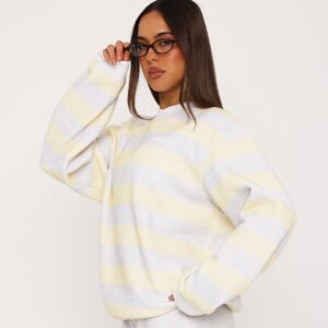 Women wearing a lemon yellow and grey striped oversized sweatshirt, front view
